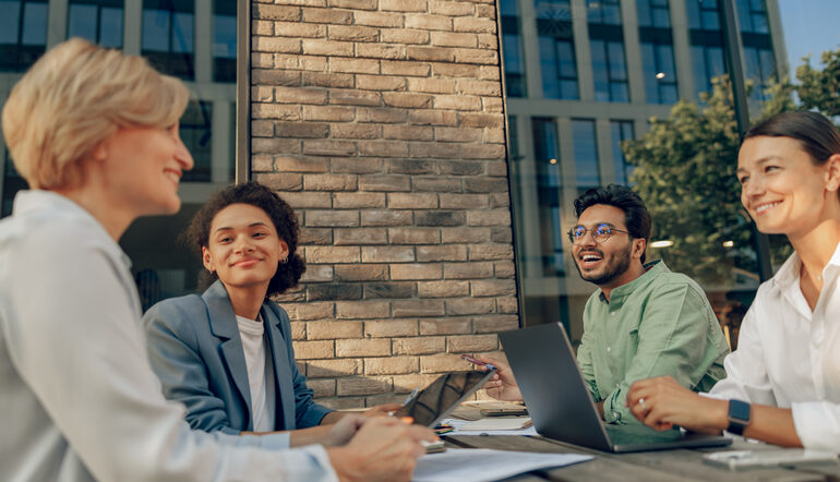 Smiling colleagues developing business ideas together