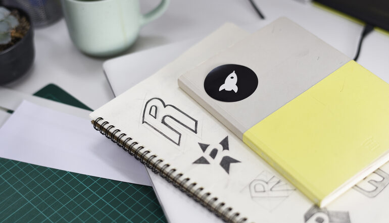 Creative workspace with notebooks and design sketches