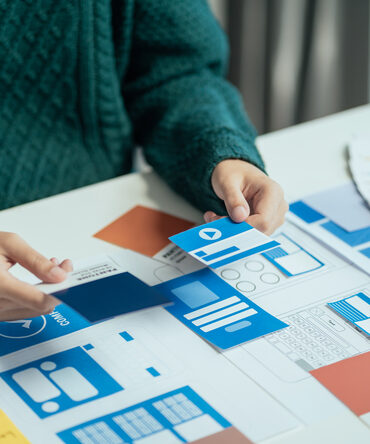 Printed mobile app wireframes under review