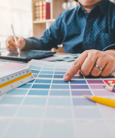 Designer matching colour swatches at a workstation