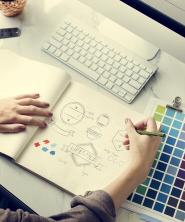Logo concepts being sketched by hand