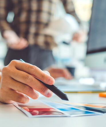Designer holding a fan of colour palette samples